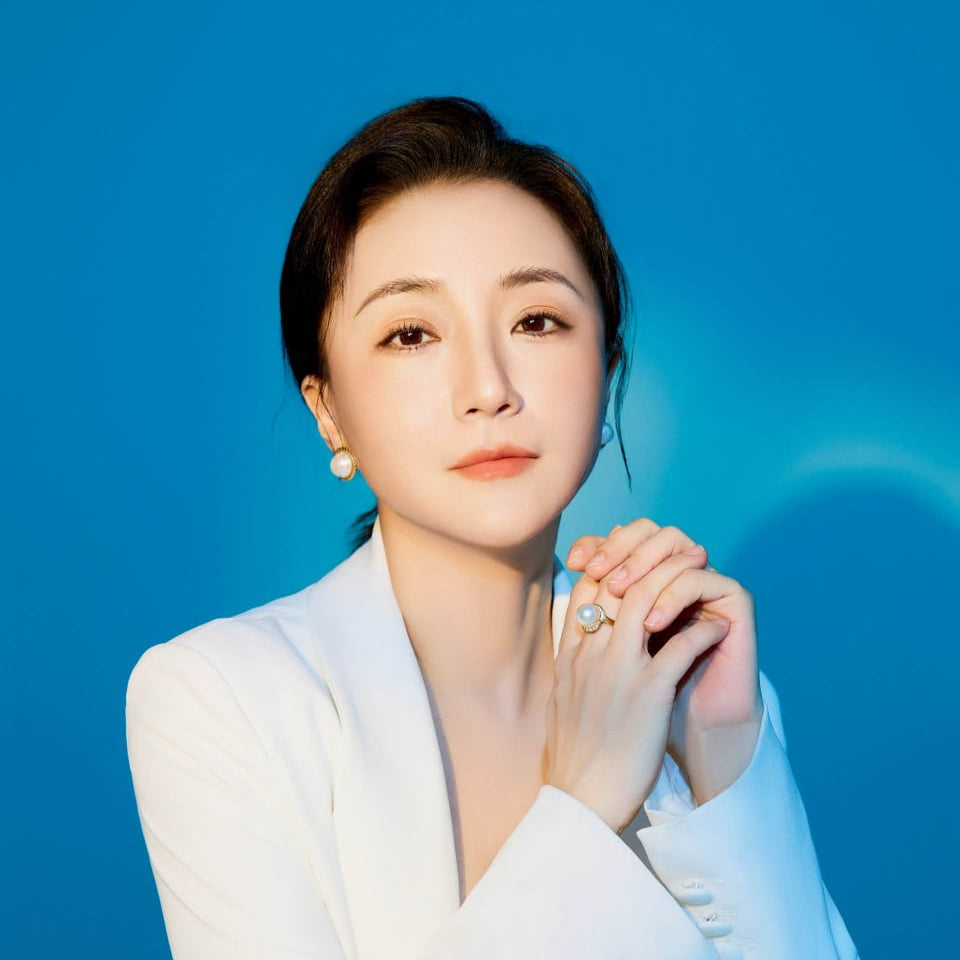 Woman in a white outfit against a blue background