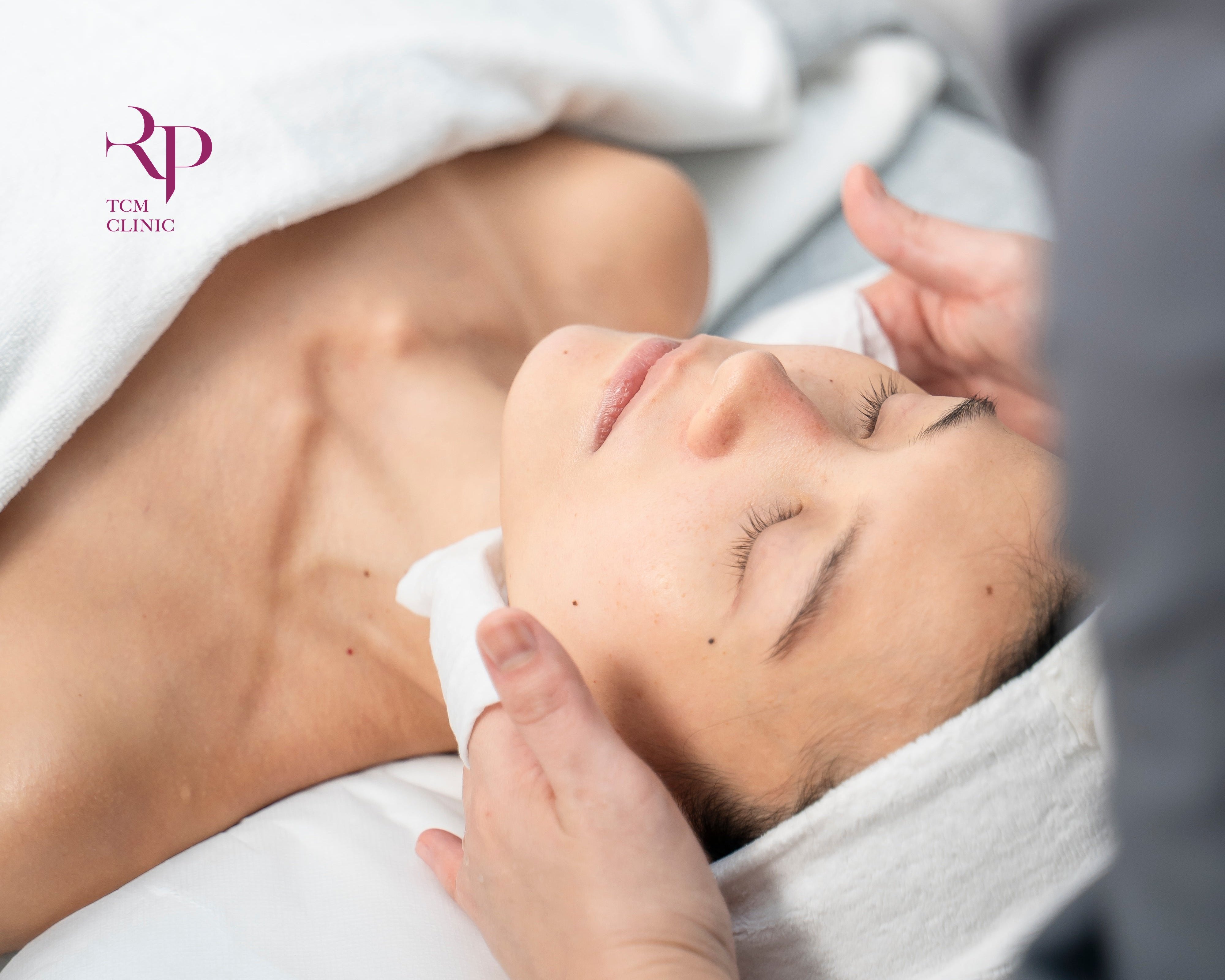 Person receiving a facial treatment in a clinical setting