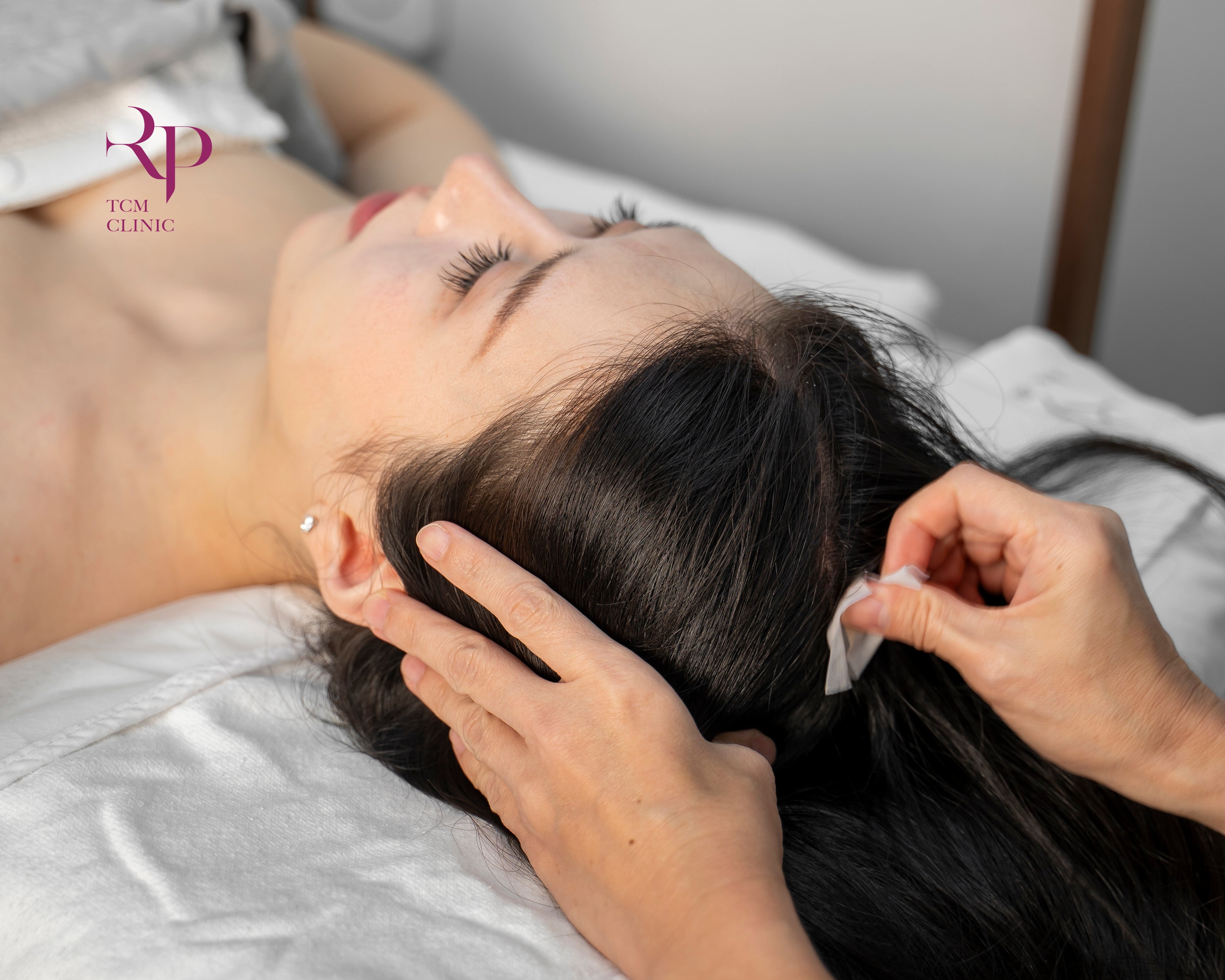 Person receiving ear cleaning treatment in a clinical setting